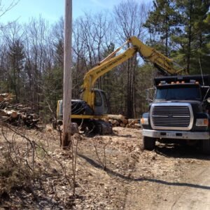 Excavator and dump truck preparing a building site in Simcoe County