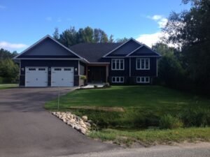 Finished home and driveway with restored landscape