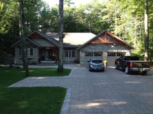 Finished home with interlock driveway on a wooded lot