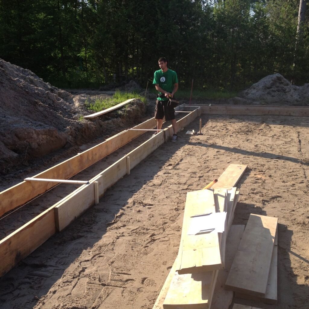 Footing forms set on a sand lot near Georgian Bay