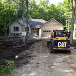 Skid steer grading a new home site